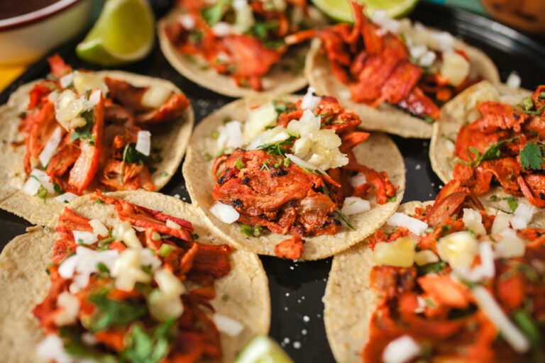 Mexican menu — tacos al pastor with onion, cilantro and lime