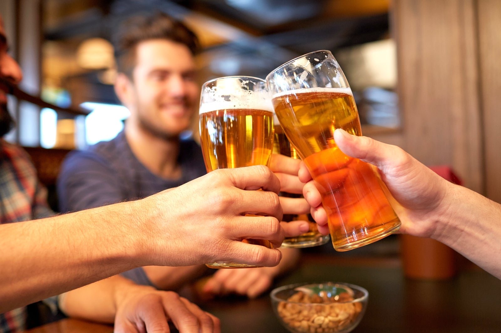 Near by me pubs — friends toasting craft beer pints at a pub table
