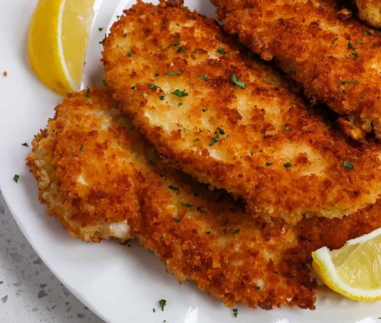Crispy chicken schnitzel with lemon wedges — schnitzeria menu 2026